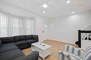 Bright and inviting living room with cozy seating and natural light, perfect for relaxing after a day of exploring.