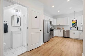 Discover a kitchen designed for foodie dreams, complete with stainless steel appliances and ample cabinet space to inspire your culinary creations.