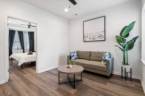 Step into this visually appealing living room, where a vibrant houseplant breathes life and energy into the inviting space.