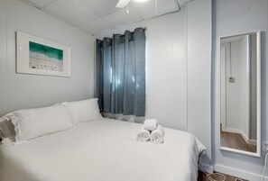 Our queen bedroom with a large mirror is the perfect spot to freshen up and look your best before exploring the city.