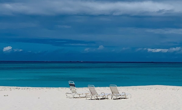 Treasure Cay Beach at peak time featuring relaxing lawn chairs.
