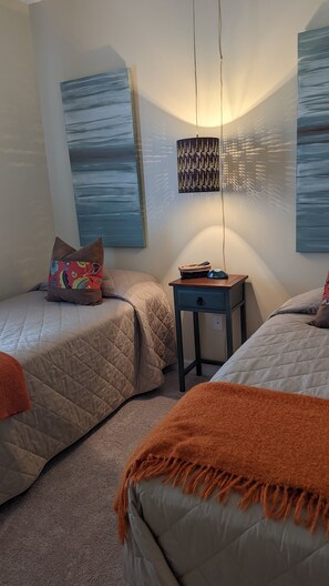 Bedroom 2 has two twin beds with a smart TV.