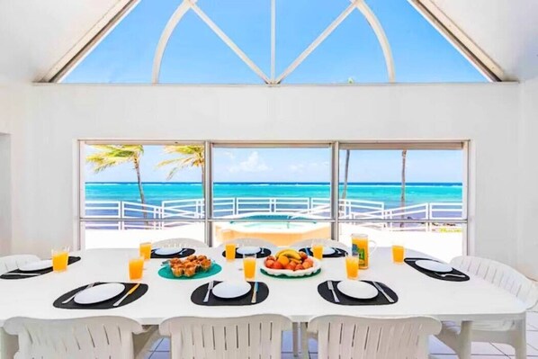 Dine with a view! Enjoy locally grown and caught Caribbean feasts at our 8-seater dining table overlooking Rum Point. ️ #LuxuryGetaway