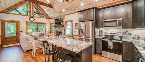 Open concept living room & Kitchen with vaulted ceilings plenty of natural light