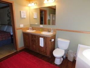 Double sink , toilet, soaking tub and a shower