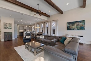 Expansive living room with 14 foot ceilings, original art and leather couch adorns this Austin Texas Home.