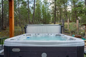 Private backyard with fire pit & hot tub.