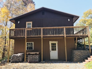 Side of cabin. Private parking. Walkway to the right. Fire pit to the left. 
