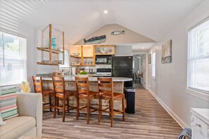 Sun-filled kitchen, equipped for cooking and entertainment.