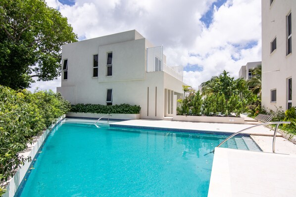 Tranquil pool area with access to the gardens. Bathroom facilities nearby