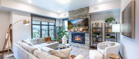 Spacious living room with oversized couch and gas fireplace