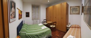 First bedroom with double bed and single bed