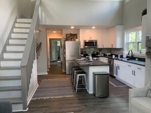 View from Front French Doors into Living Room/Kitchen/Up Stairs to Loft