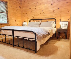 King bed in master bedroom with private bathroom and smart tv