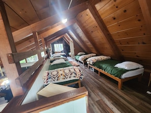 Loft with 5 twin beds and a queen bed. 