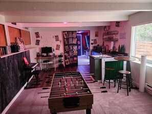 game room with 4 in 1 table, wet bar, movie room, and more.