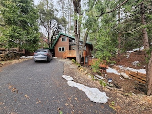 front of home with large driveway for several vehicles, carport as well.