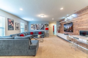 Flat Screen TV, Work Station (If You Must), Large Sectional Sofa and Cool Décor
