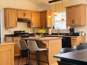 Clean, happy, fully stocked kitchen with plenty of seating 