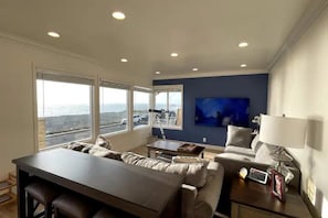 Living room with 270-degree ocean view, beach access, are across the street.