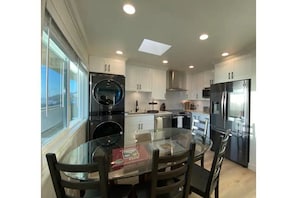 Kitchen with a smart refrigerator, W/D, dishwasher, microwave, range and table