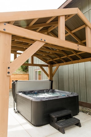 Hot tub is under cover to protect from weather. It's located in the super private, fully fenced side patio. 