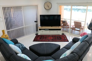 Living Room with large Smart TV, Bauhm Soundbar and Bose Sound system.