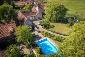 School House, Burnham Thorpe:  Aerial view of gardens and swimming pools