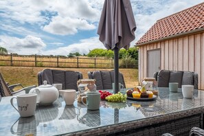 Field View, Sedgeford: Patio with outdoor dining furniture and barbecue