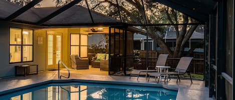 Beautifully lit lanai with oversized heated pool for lounging and grilling.