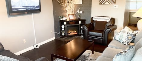 Family room, with fireplace and queen pullout sofa bed. 