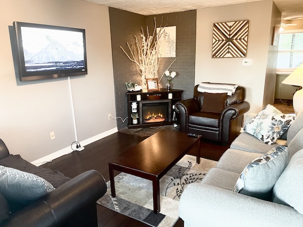 Family room, with fireplace and queen pullout sofa bed. 