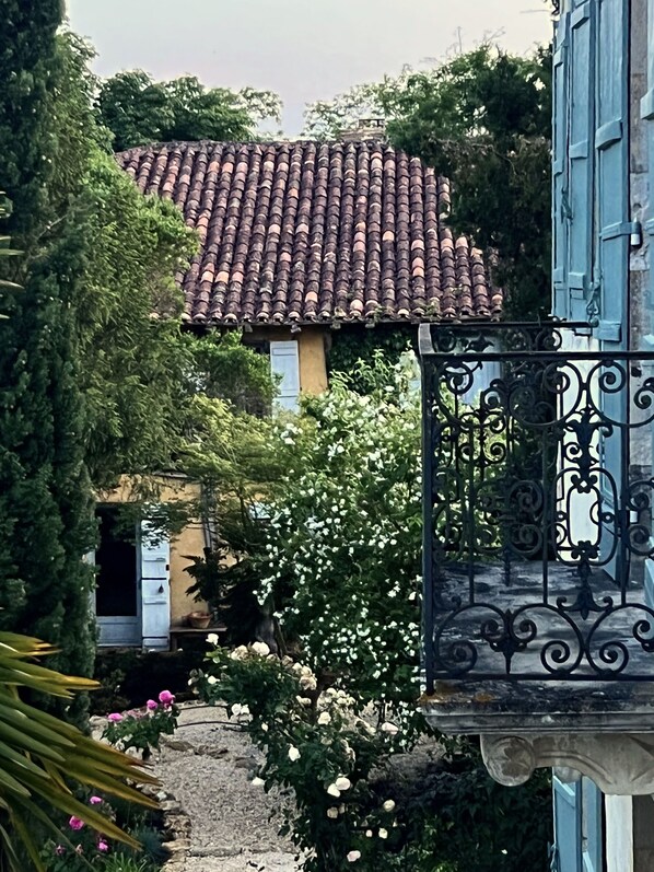 Through the rose garden to the Maison de Gardien. A family home. 