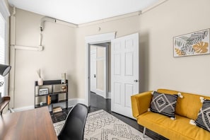 Separate office space with book shelf, closet, workstation, and twin futon.