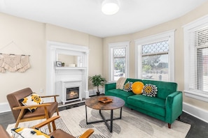 Original lead glass windows, plaster fireplace details, and ample seating for up to 4 guests.
