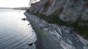 Drift wood along the beach. Beach is accessible through the pier shown top left.