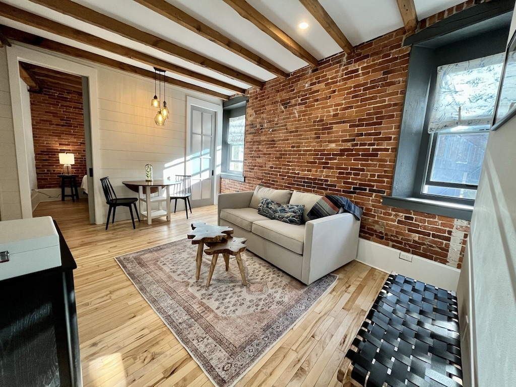 Exposed brick and wooden beam rafters in a modern vacation rental in New Hampshire