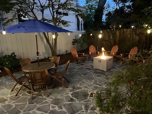 Outdoor patio with lights and fire pit