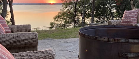 Waterfront sunset over Lake and Comanche Peak, surrounded by trees & water