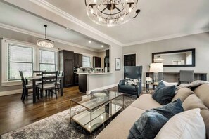 Bright, open living area featuring a comfortable sofa and plenty of seating for everyone.