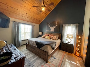 Primary bedroom with memory foam king bed, TV, connects to bathroom