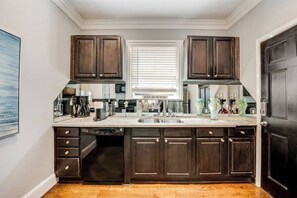 A meticulously designed kitchen with modern appliances and high-end finishes, fully equipped for all your cooking needs.