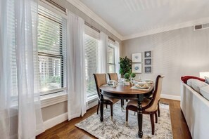 Sophisticated dining area with sleek, modern seating for four, offering an ideal setting for a memorable meal.