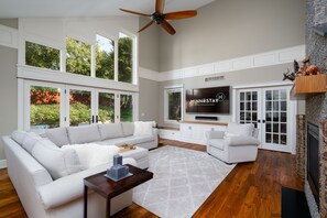 The elegant living room has gorgeous windows, vaulted ceilings and plenty of space for everyone to enjoy