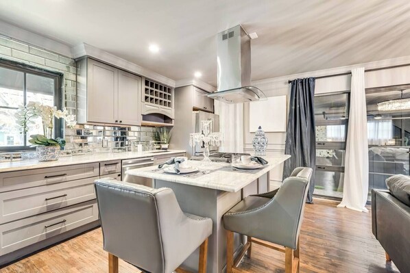 Spacious kitchen with island and gas range. Perfect for cooking!.