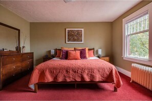 Spacious bedroom with king size bed, lamps have USB ports and outlets.