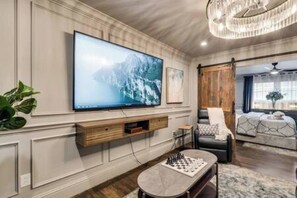 Relax and unwind in the spacious open-concept living area, featuring a 65" Smart TV—perfect for enjoying your favorite shows.