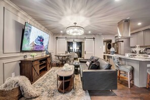 Relax on the comfy leather sectional  offering great views of the 65'' smart TV—perfect for catching up on your favorite shows.
