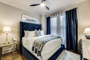 Bedroom #1 is cozy and bright, featuring luxurious Egyptian cotton linens and a plush mattress for a restful night's sleep. The room is beautifully lit with natural light and includes blackout curtains for added comfort and privacy.