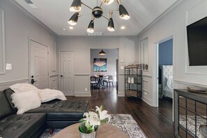 Living room with designer finishes and Large smart TV. 